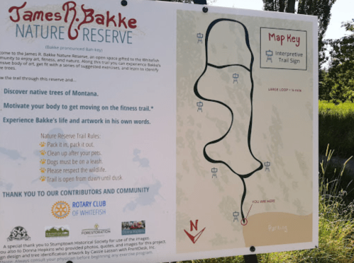 Sign for James R. Bakke Nature Reserve featuring a trail map, rules, and information about the reserve's features.