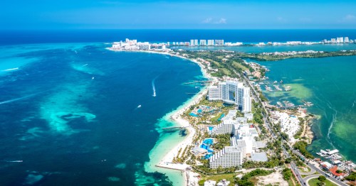 aerial shot of hotels and white-sand beaches in cancun mexico