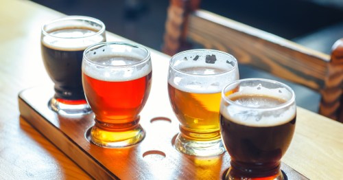 Four samples of craft beer served at a brewery.