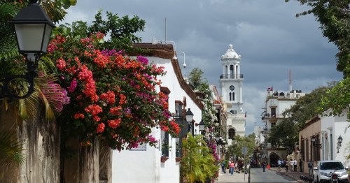Calle Arzobispo Merino street view of santo domingo in the dominican republic with the town hall in the distance