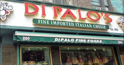 Storefront of Di Palo's, featuring a sign for fine imported Italian cheese, established in 1925.