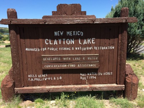 Sign for Clayton Lake in New Mexico, detailing fishing, waterfowl restoration, and conservation efforts. Built in 1954.