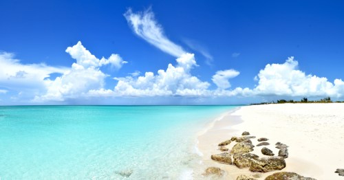 a sugar-white sand beach against the turquoise water of the caribbean, turks & caicos
