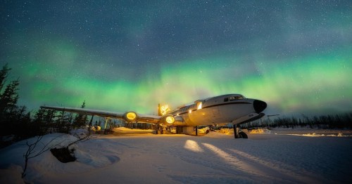 white airplane house with the northern lights in the background