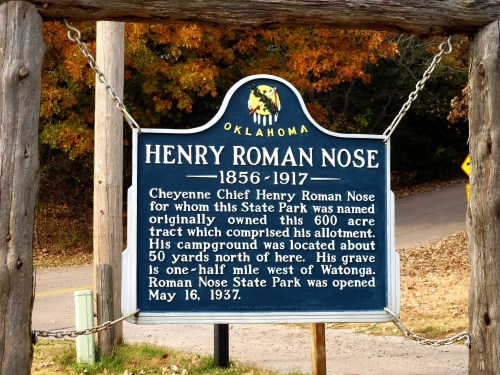 Historical marker for Henry Roman Nose, Cheyenne Chief, detailing his legacy and the establishment of Roman Nose State Park.