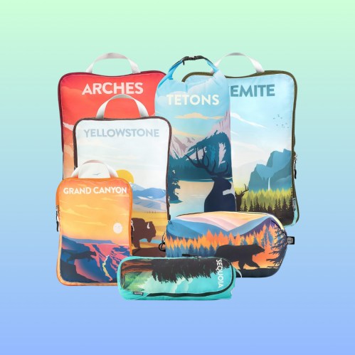A collection of colorful travel bags featuring national park designs, including Arches, Yellowstone, and Grand Canyon.