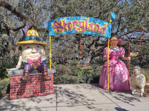 Colorful entrance to Storyland featuring a large Humpty Dumpty, a princess, and a sheep statue.