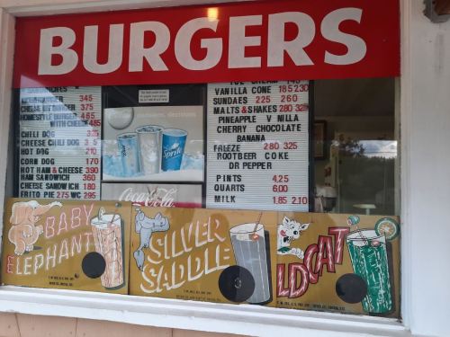 Menu display featuring burgers, drinks, and desserts with colorful graphics of drinks and playful animal illustrations.