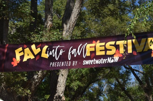 Banner for "Fall into Fall Festival" presented by SweetwaterNOW, surrounded by trees and autumn leaves.