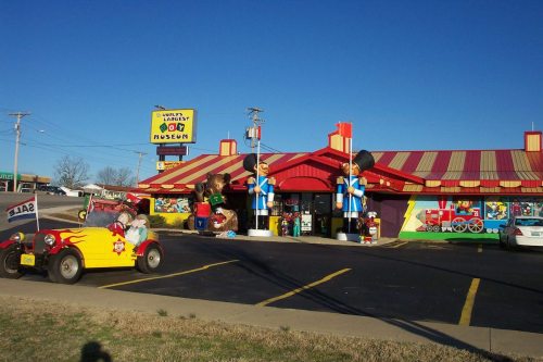 A colorful building with large cartoon figures outside, labeled as the "World's Largest Toy Museum."