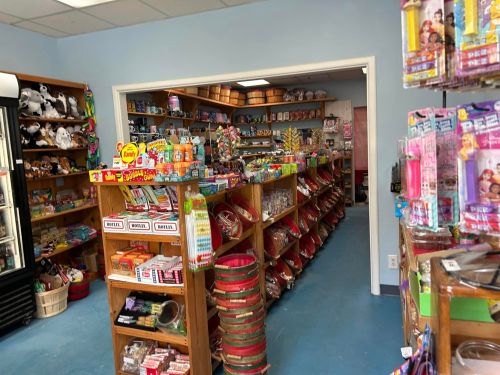 A colorful store interior filled with shelves of candy, toys, and various novelty items.