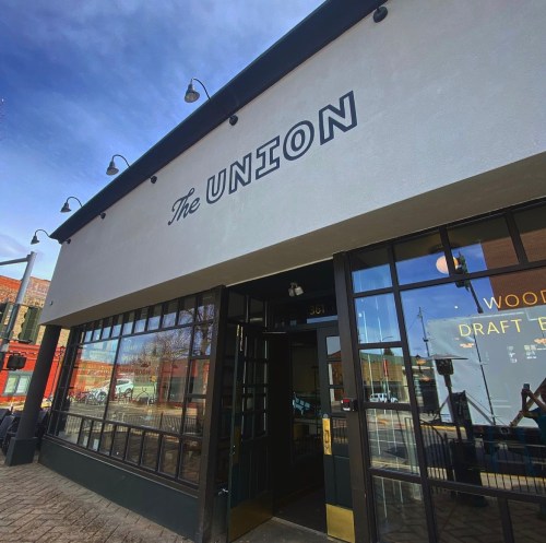 Exterior of a building with the sign "The Union" above large windows, showcasing a welcoming entrance.