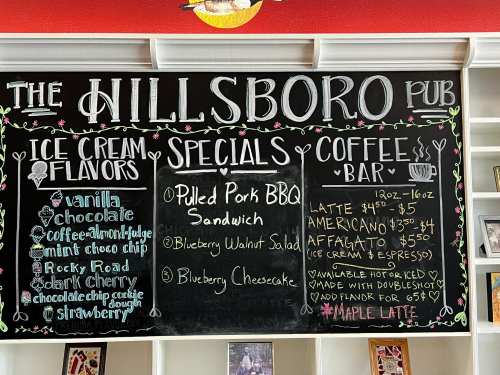 Chalkboard menu at The Hillsboro Pub listing ice cream flavors, specials, and coffee options.