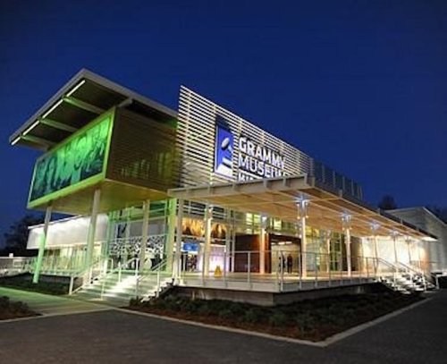 The Grammy Museum at night, featuring modern architecture and illuminated signage.