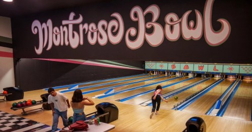 A bowling alley with colorful lanes and a sign reading "Montrose Bowl." Two people watch as a third bowls.