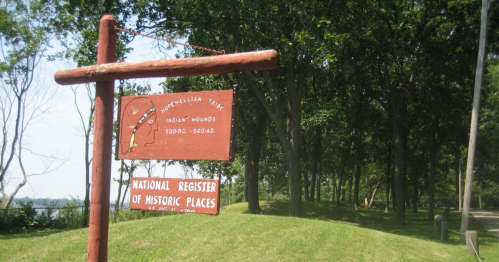 Sign marking the location of Indian Mounds, listed on the National Register of Historic Places, surrounded by trees.