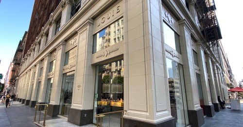Exterior view of a modern building with large glass windows and the name "Louie" displayed prominently.