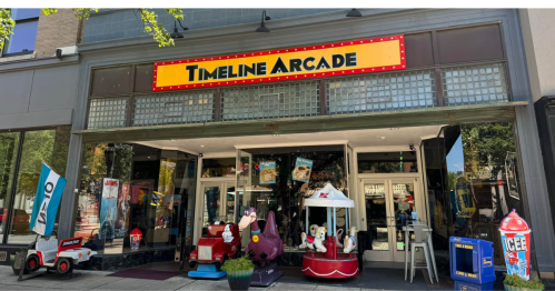 Exterior of Timeline Arcade featuring colorful arcade games and a welcoming entrance with signage.