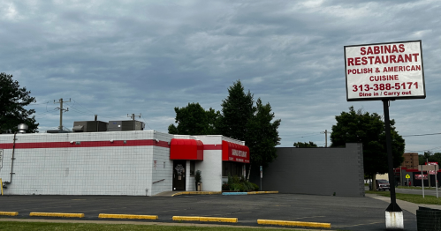 Exterior of Sabinas Restaurant, featuring a sign for Polish and American cuisine, with a cloudy sky in the background.