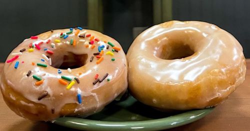 Two glazed donuts on a green plate at Zeke's Breakfast and Bakes in Morgantown, West Virginia