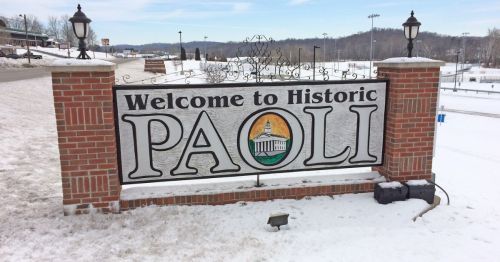 A large white sign that says "Welcome to Historic Paoli"