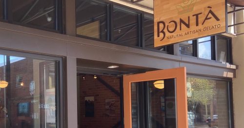 Exterior of Bontà, a gelato shop, featuring a welcoming entrance and a sign that reads "Handcrafted Artisan Gelato."