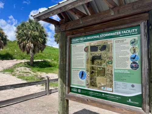 Sign for Celery Fields Regional Stormwater Facility, featuring maps and information about the area and its features.