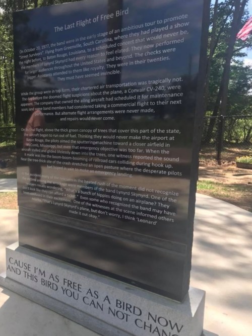 A memorial plaque detailing the story of the "Last Flight of Free Bird" with text about its significance and history.