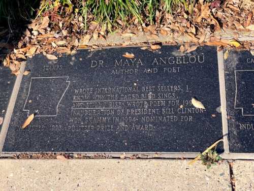 Plaque honoring Dr. Maya Angelou, detailing her achievements as an author and poet, including notable works and awards.