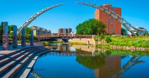 Bridges reflected in the water of downtown Sioux Falls.