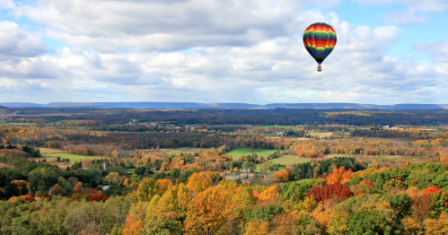 Hot air balloon above New Jersey landscape.