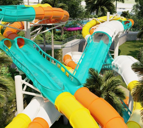 Colorful water slides twist and turn through a tropical landscape with palm trees in a water park setting.