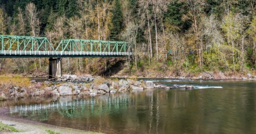 A bridge crosses over the Sandy River on a spring day near Troutdale, Oregon.