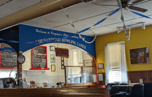 Interior of Shenandoah Bowling Lanes, featuring a snack bar, colorful walls, and festive decorations.