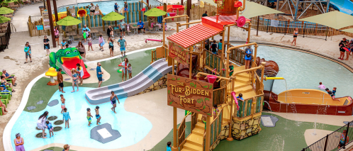 A vibrant water park scene with children playing in pools and on slides, featuring a colorful play structure.