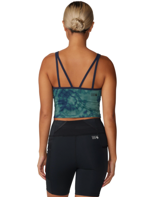 A woman in a tie-dye sports bra and black shorts, viewed from the back, showcasing a sporty outfit.