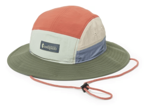 Colorful bucket hat with a wide brim and adjustable chin strap, featuring multiple fabric panels in earthy tones.