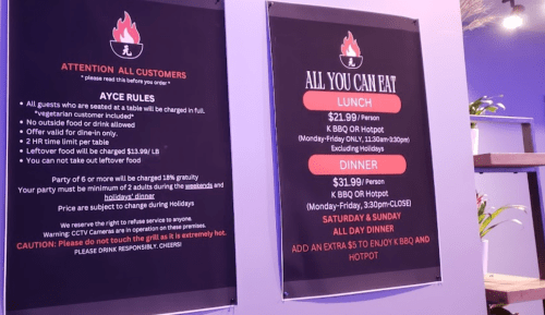 Signage detailing all-you-can-eat BBQ and hotpot pricing, rules, and hours for lunch and dinner.