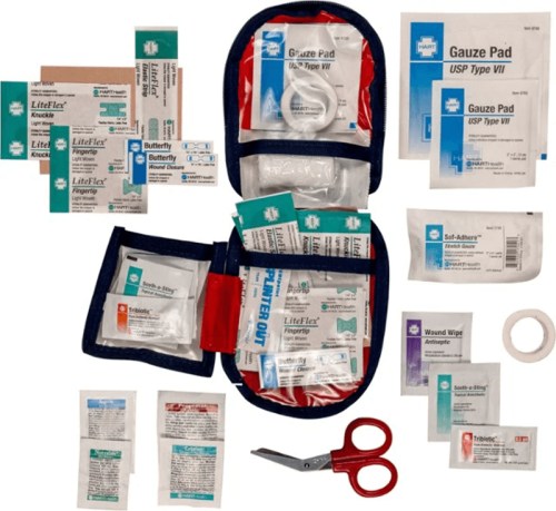 A first aid kit with various bandages, gauze pads, antiseptic wipes, and scissors arranged neatly.