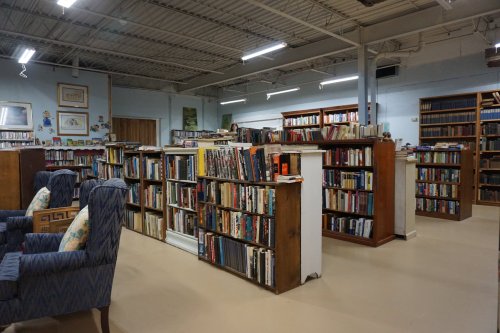 A cozy library interior with bookshelves filled with books and comfortable seating areas.