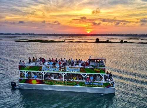 A sunset view over water with a crowded party boat, "Pie Eyed Parrot," enjoying the evening.