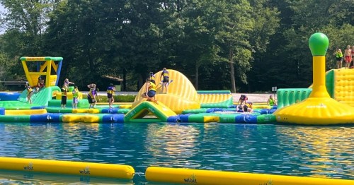 A green and yellow inflatable waterpark at Darlington County Park, a family-friendly summer spot in New Jersey.
