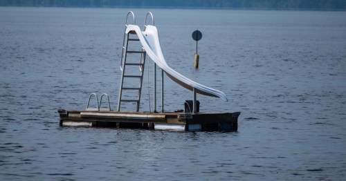 Metal slide on a floating dock on the lake.