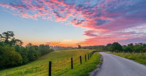 a sunrise over a dirt road in Kentucky.