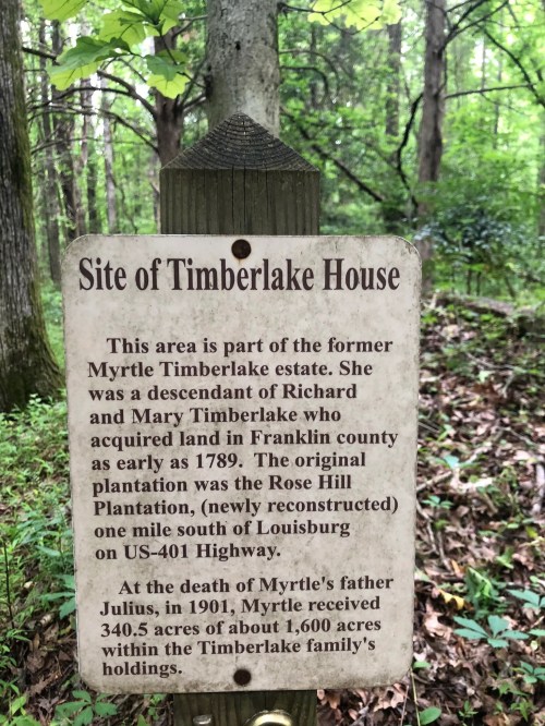 Sign marking the site of Timberlake House, detailing its history and connection to the Myrtle Timberlake estate.
