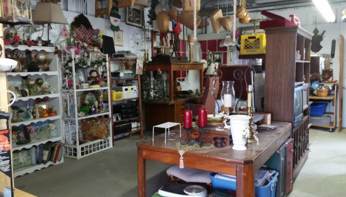 A cozy antique shop filled with various vintage items, furniture, and decorative pieces on display.