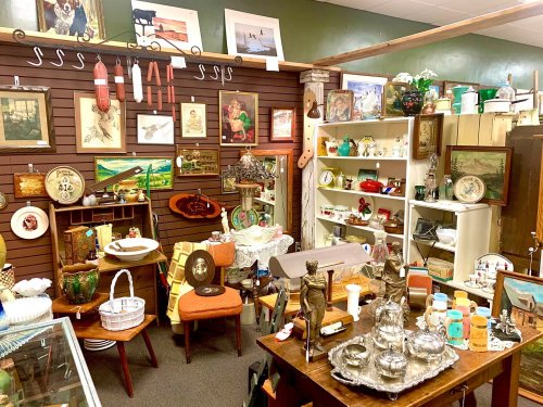 A cozy antique shop filled with vintage decor, furniture, and collectibles on display.