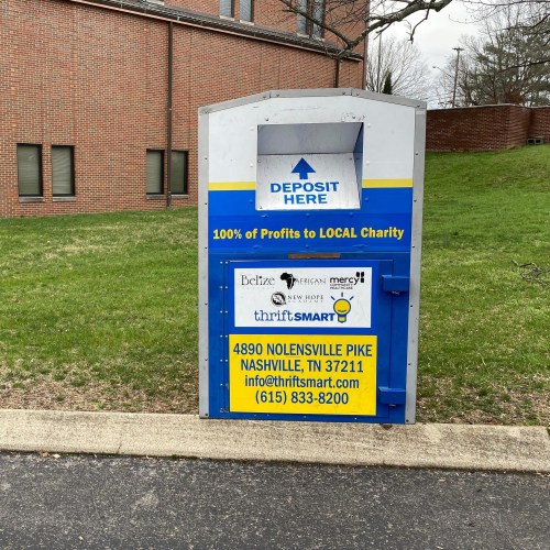 A donation bin for thrift items, promoting local charity and providing contact information for ThriftSmart in Nashville, TN.