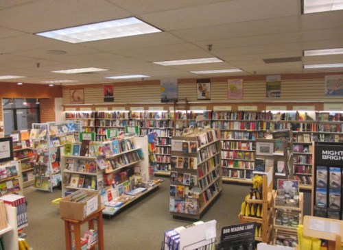 A cozy bookstore interior with shelves filled with books, reading lights, and a welcoming atmosphere.
