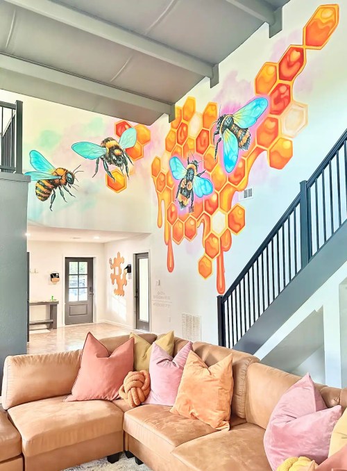 A cozy living room with a large mural of bees and honeycomb on the wall, featuring vibrant colors and a modern design.
